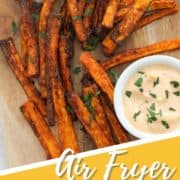 fries on a wooden serving board with text overlay "air fryer carrot fries".