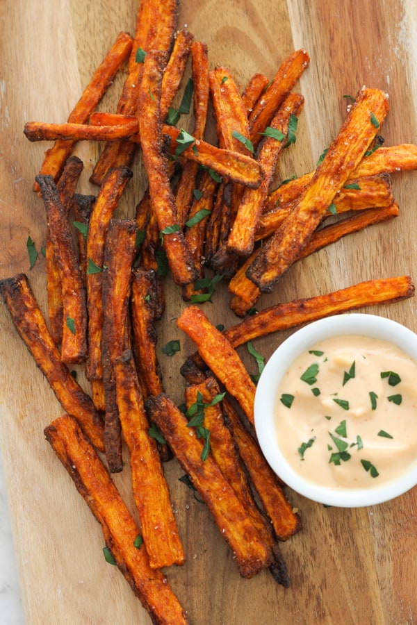 carrot fries on a wooden serving board.