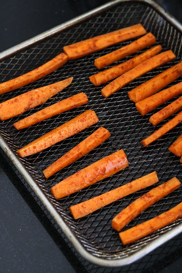 carrot fries on an air fryer rack.