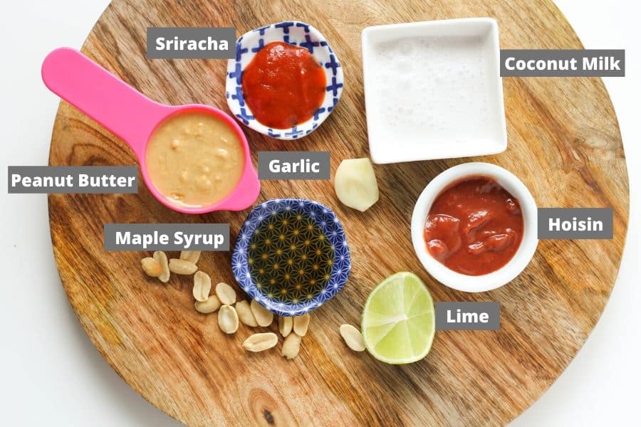 ingredients for peanut hoisin sauce on a wooden board.