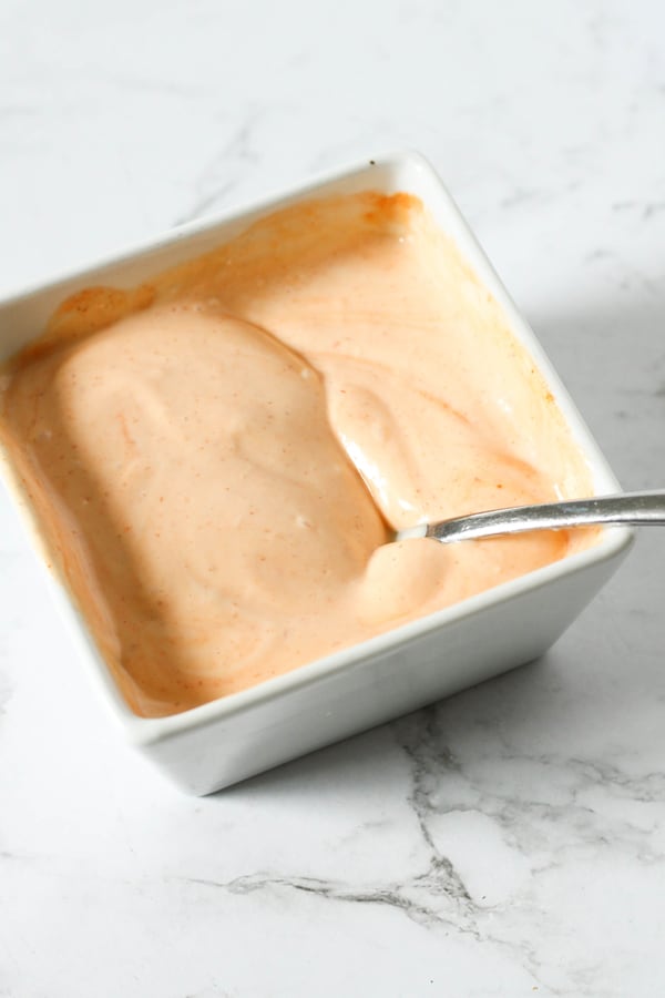 spicy mayonnaise in a square serving dish.