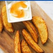 potato wedges on a wooden board with text overlay "air fryer crispy potato wedges".