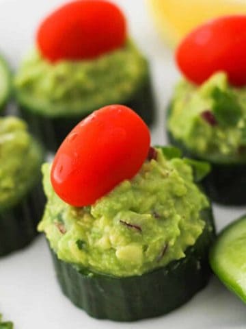 cucumber bites on a white plate.