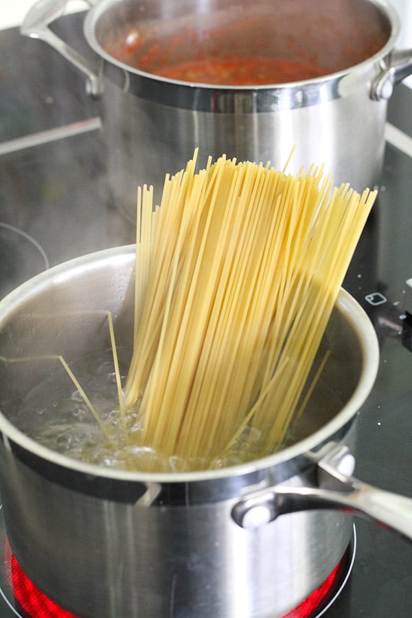 spaghetti in a saucepan of water.