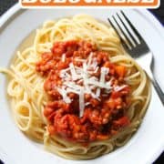 spaghetti and sauce on a white plate with text overlay "vegan lentil bolognese".