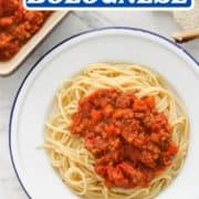 spaghetti and sauce on a white plate with text overlay "vegan lentil bolognese".