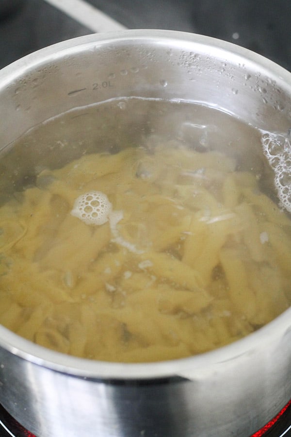 penne pasta in a saucepan of water.