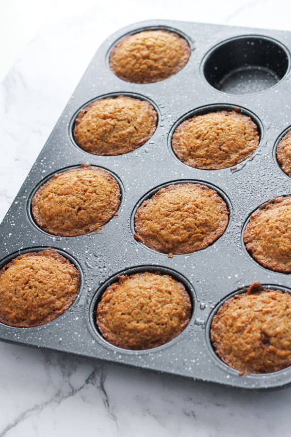 carrot cupcakes in a muffin tin.
