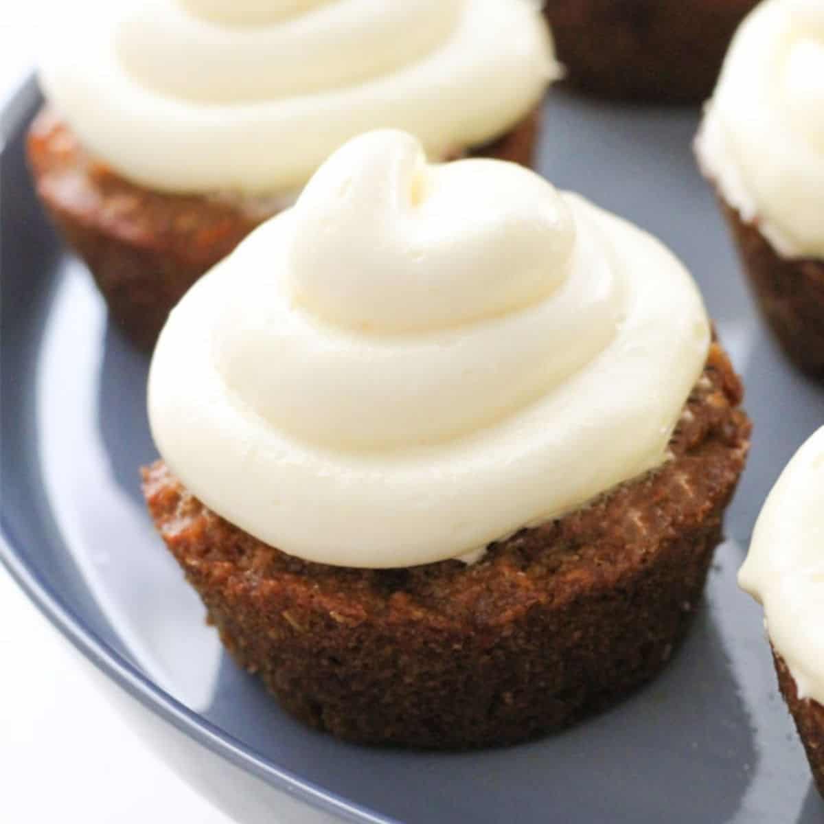 carrot cupcakes on a cake stand.