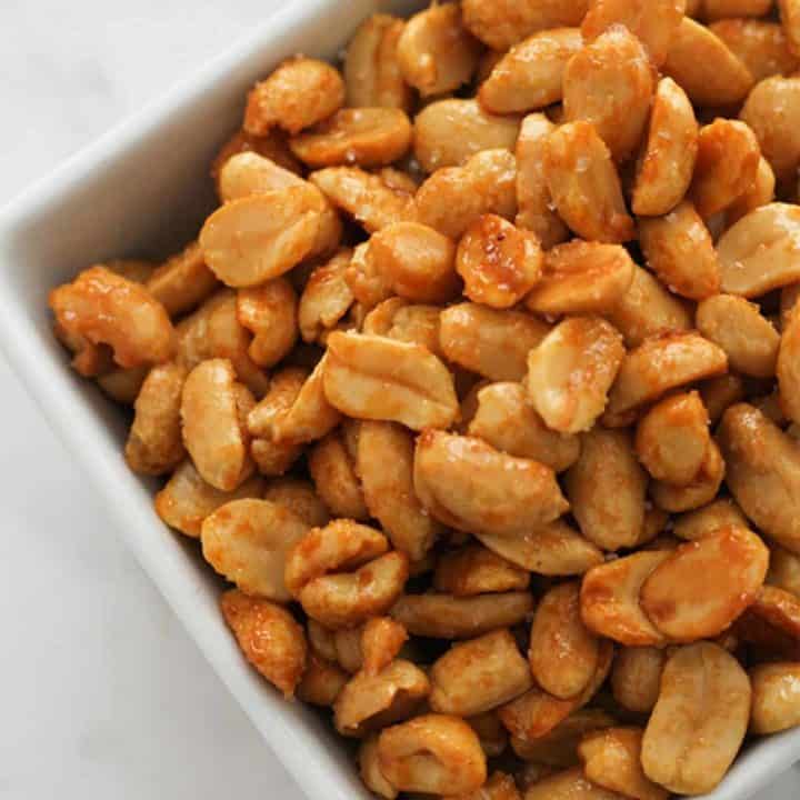 honey roasted peanuts in a white bowl.