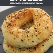 bagels stacked on a grey plate with text overlay "air fryer bagels using 2 ingredient dough".