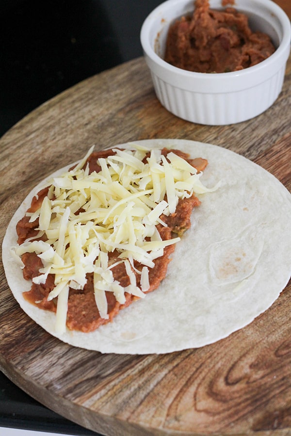 tortilla topped with beans and cheese.