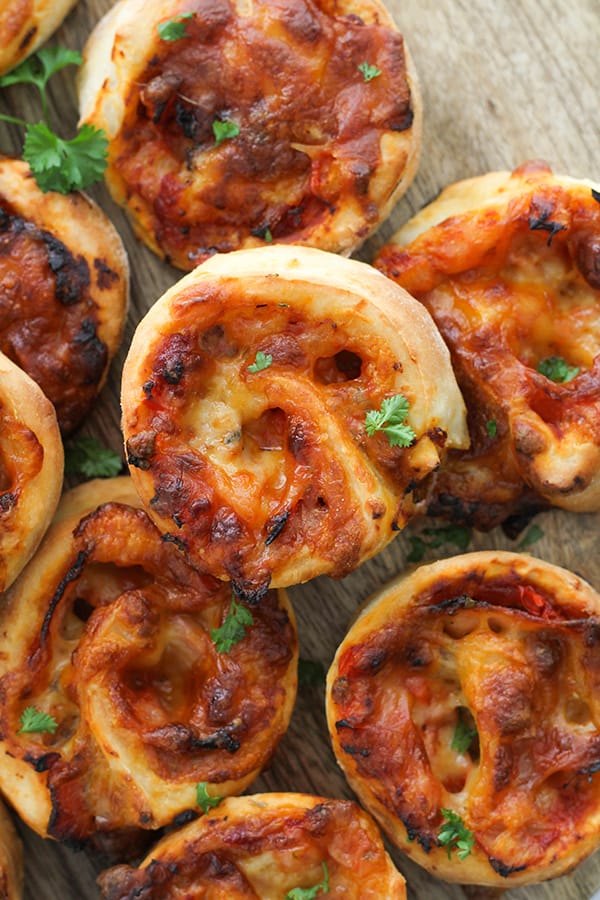 pizza pinwheels on a wooden board.
