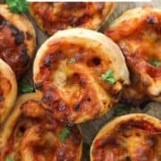 pizza scrolls piled on top of each other with text overlay "air fryer pizza pinwheels".