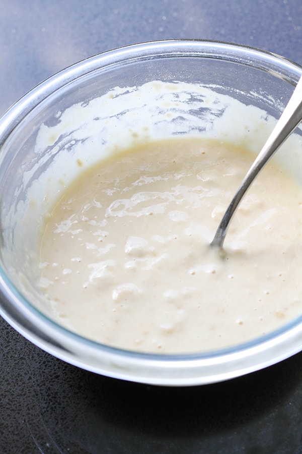 a glass bowl filled with pancake batter.