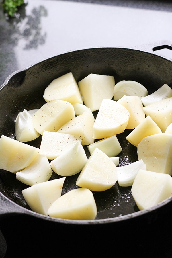 potatoes in a cast iron pan.