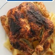 roast chicken and potatoes on a white plate with text overlay "Greek roast chicken".