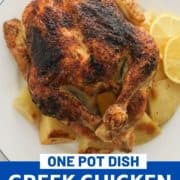 roast chicken and potatoes on a white plate with text overlay "Greek chicken and potatoes".