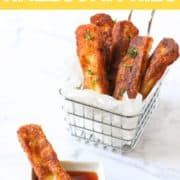 halloumi fries in a wire basket with text overlay "golden & crispy halloumi fries".