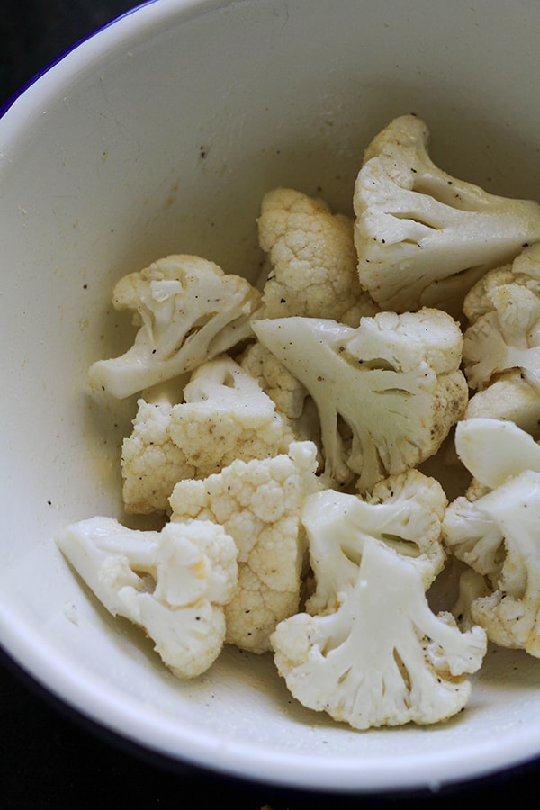 cauliflower florets in a white bowl. 