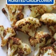 roasted cauliflower on a white plate with text overlay "air fryer roasted cauliflower".