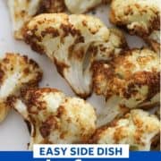 roasted cauliflower on a white plate with text overlay "air fryer roasted cauliflower".