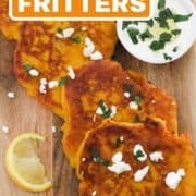 fritters laid on top of a wooden board with text overlay "pumpkin fritters".