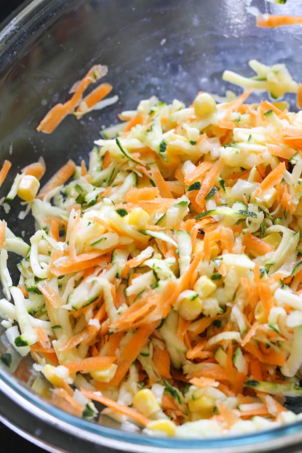 shredded zucchini and carrot in a glass bowl.