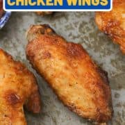 chicken wings on a metal tray with text overlay "air fryer chicken wings".