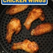 chicken wings in an air fryer basket with text overlay "crispy air fryer chicken wings".