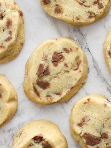 chocolate chip shortbread cookies on a marble background.