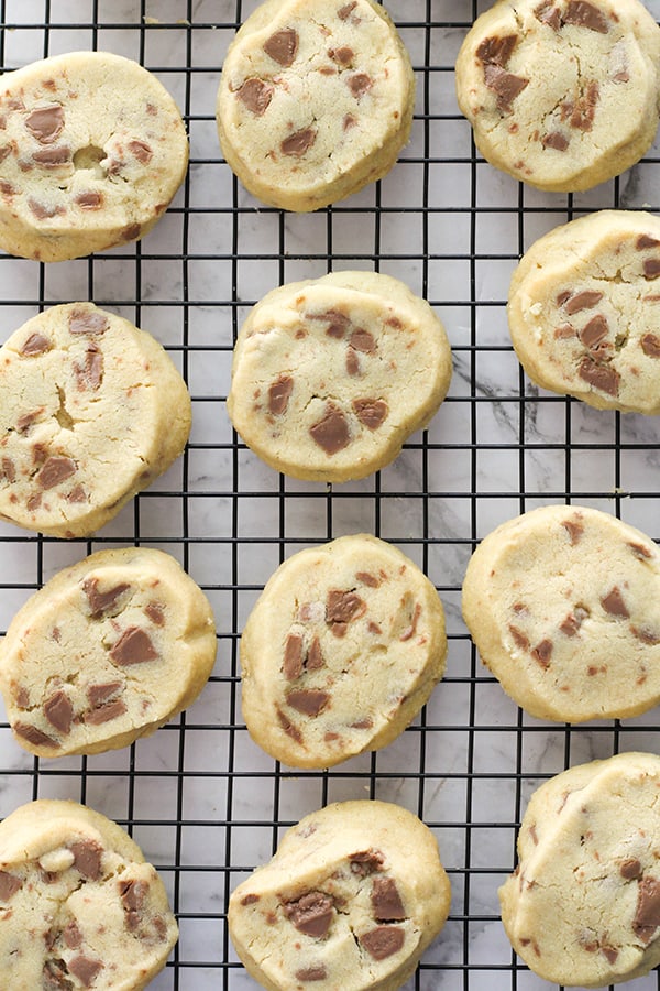 chocolate chip shortbread cookies on a wire cooling rack.
