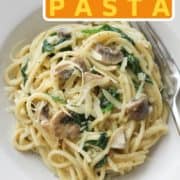 pasta in a white bowl with text overlay "creamy mushroom and spinach pasta".