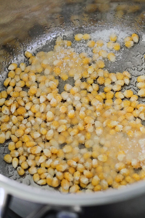 popcorn kernels and sugar in a saucepan.