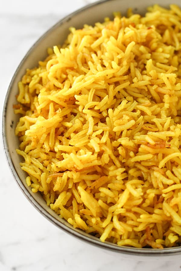 yellow rice in a grey bowl.