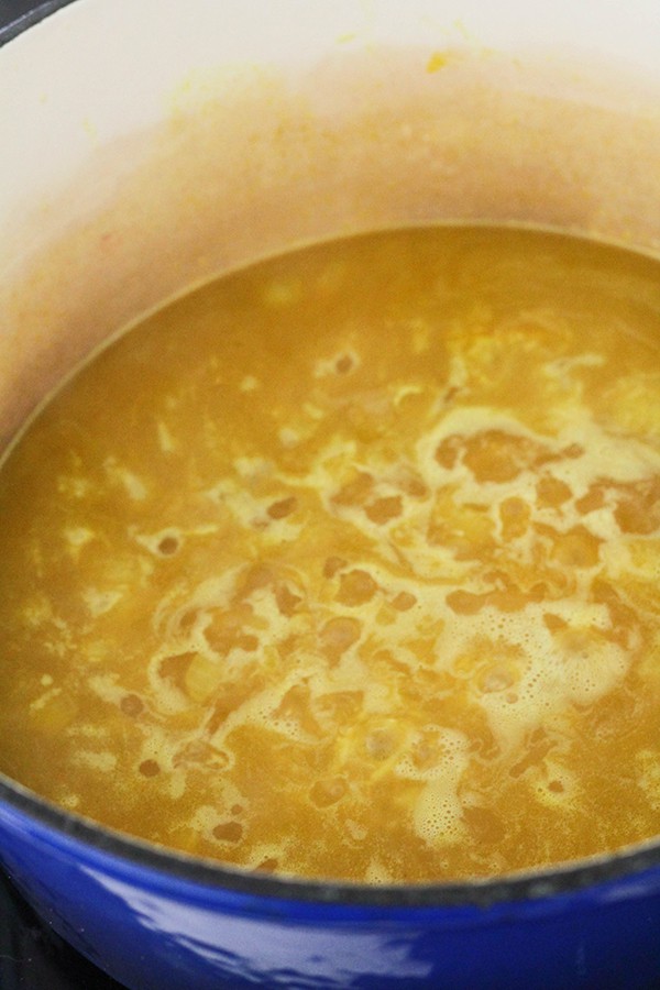 chicken stock and rice in a dutch oven.
