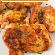 chicken thighs on a plate with text overlay "air fryer chicken thighs".