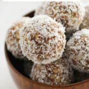 energy balls in a wooden bowl with text overlay "coconut + date energy balls".