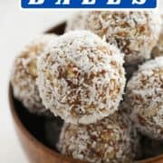 energy balls in a wooden bowl with text overlay "coconut + date energy balls".