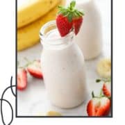 smoothie in a small bottle topped with a strawberry and text overlay "strawberry yogurt smoothie".