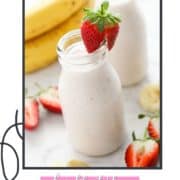 smoothie in a small bottle topped with a strawberry and text overlay "strawberry yogurt smoothie".