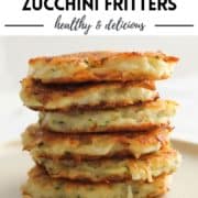 stack of fritters on a plate with text overlay "potato & zucchini fritters".