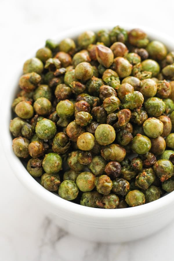 crunchy roasted peas in a white bowl.