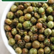 roasted peas in a white bowl with text overlay "air fryer crispy peas".
