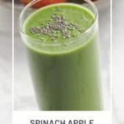 green smoothie in a tall glass topped with chia seeds with text overlay "spinach apple smoothie".