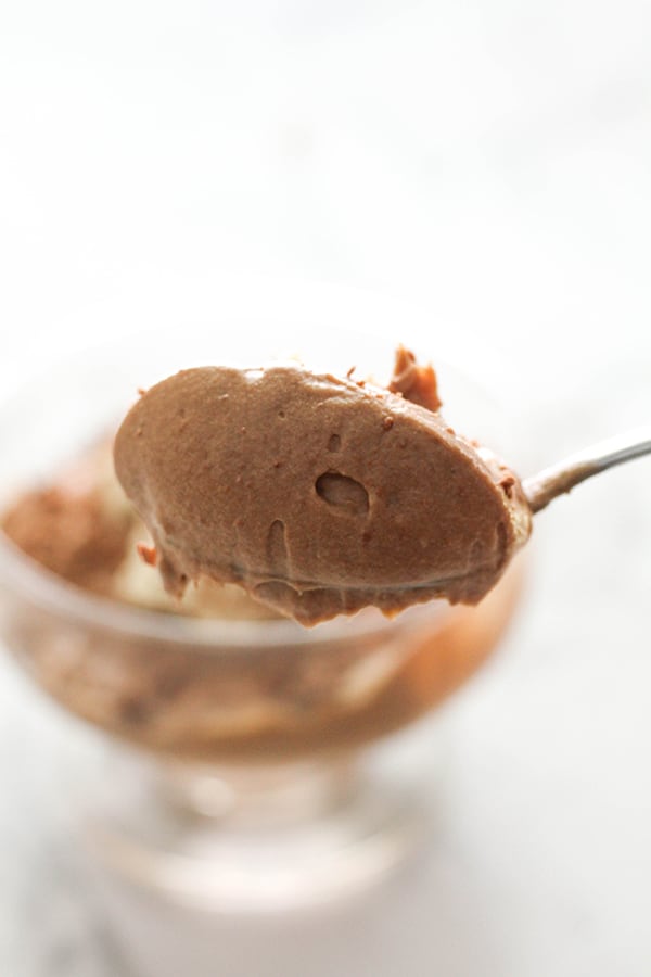 a spoon holding chocolate mousse.