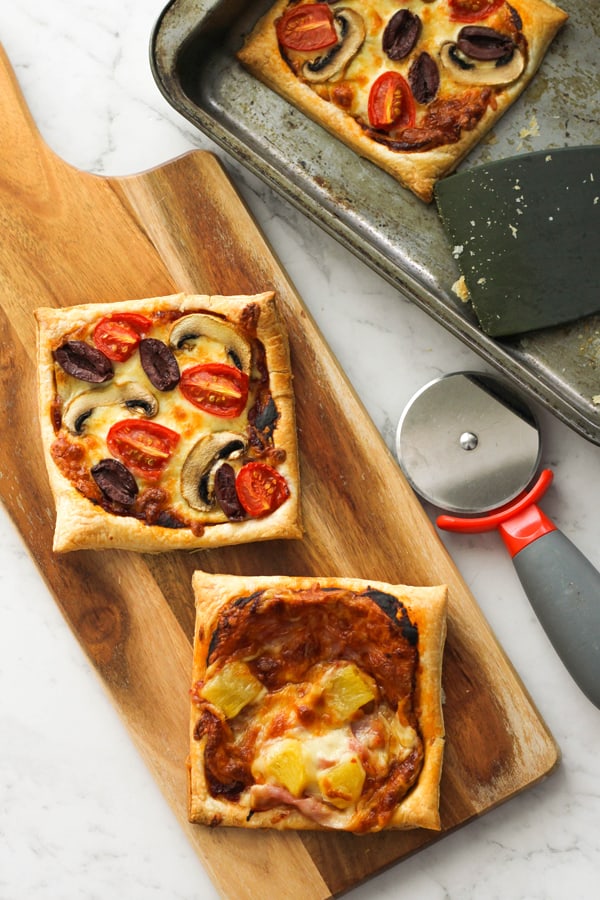 puff pastry pizzas on a wooden board.
