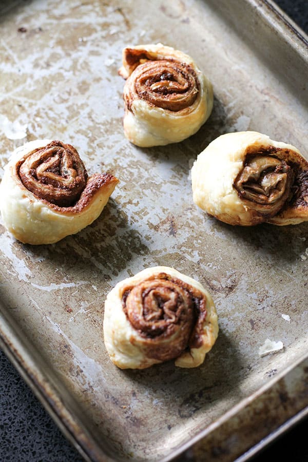 nutella puff pastry pinwheels on a baking tray.