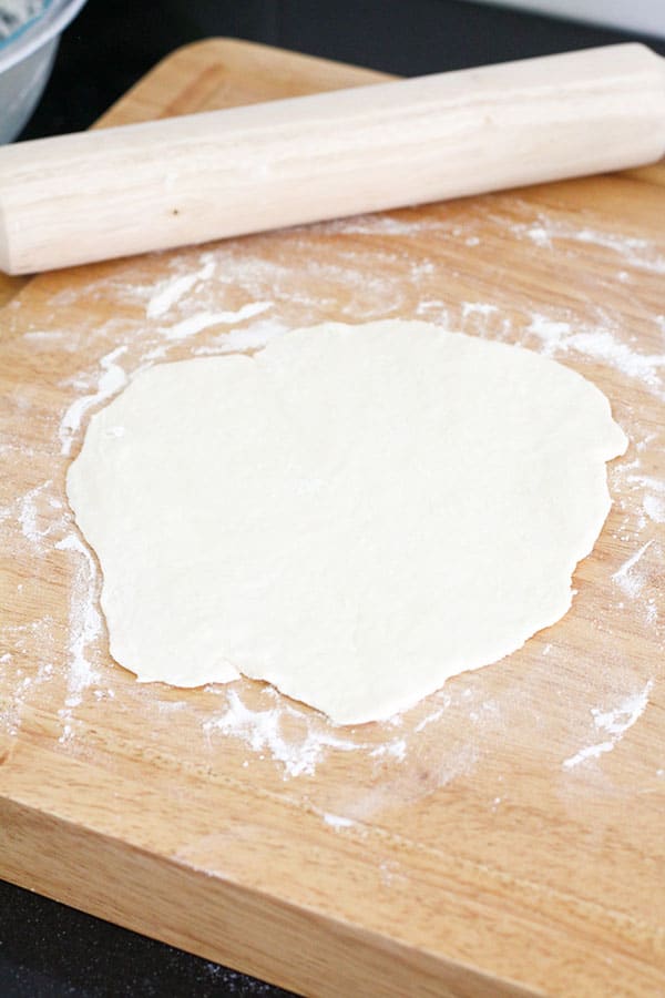 dough rolled out on a wooden board.