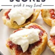 scone topped with jam and cream on a plate with text overlay "air fryer scones".